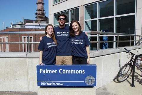 Student Staff in front of Palmer Commons Sign