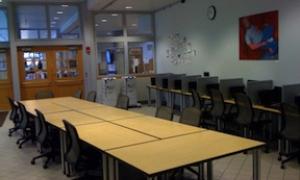 Plaza room in palmer commons with a large conference table in the center with chairs around